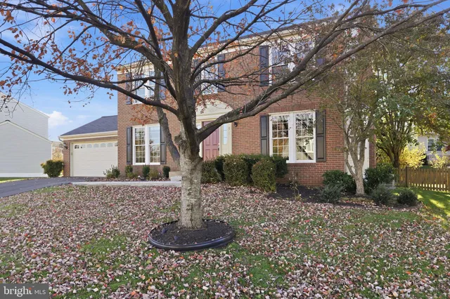 a front view of a house with a yard garage and outdoor seating