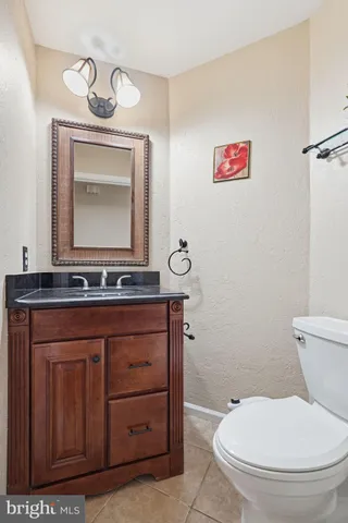 a bathroom with a toilet a sink and mirror