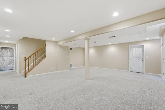 an empty room with windows and entrance to other room