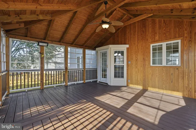 a view of backyard with wooden floor and iron fence