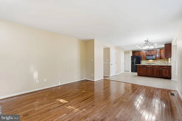 a view of a kitchen with furniture and wooden floor