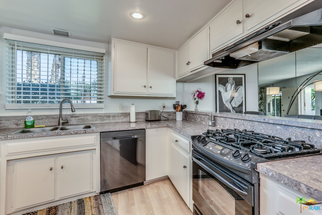 1855 Ramon Road, Unit 3 Palm Springs, CA 92264 - Photo 12 of 38 a kitchen with stainless steel appliances granite countertop a stove and a sink