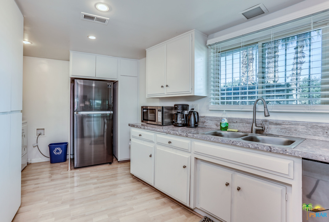 1855 Ramon Road, Unit 3 Palm Springs, CA 92264 - Photo 13 of 38 a kitchen with stainless steel appliances granite countertop a refrigerator sink and cabinets