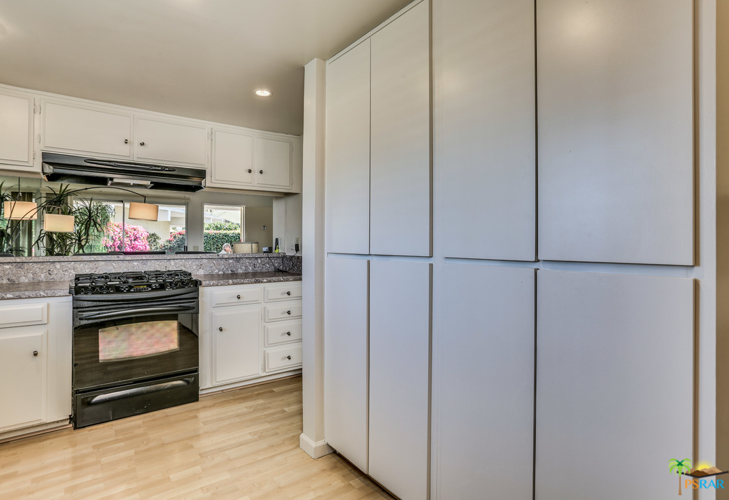 1855 Ramon Road, Unit 3 Palm Springs, CA 92264 - Photo 15 of 38 a kitchen with stainless steel appliances a stove and a refrigerator