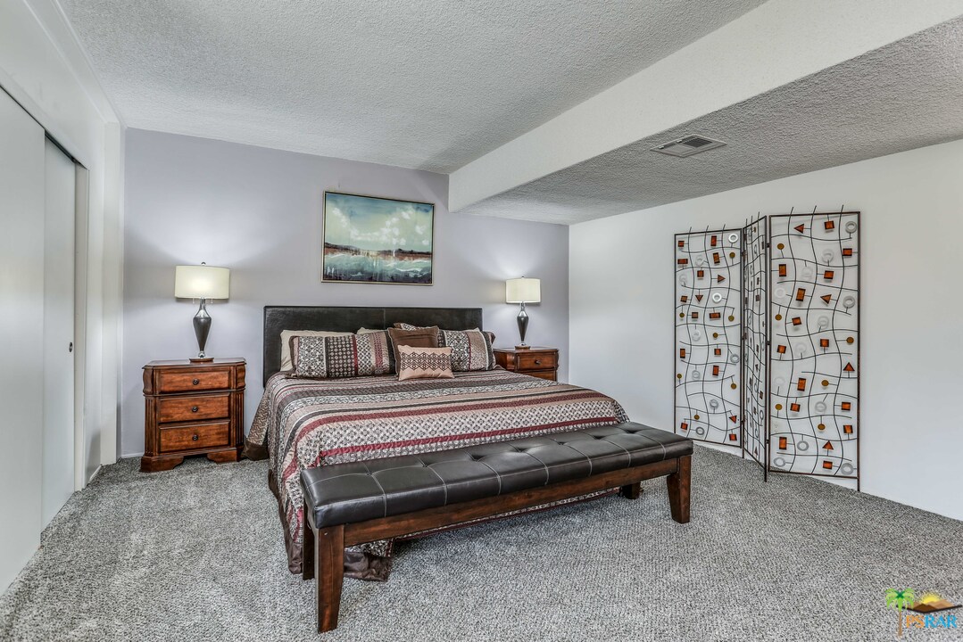 1855 Ramon Road, Unit 3 Palm Springs, CA 92264 - Photo 17 of 38 a spacious bedroom with a bed and a window