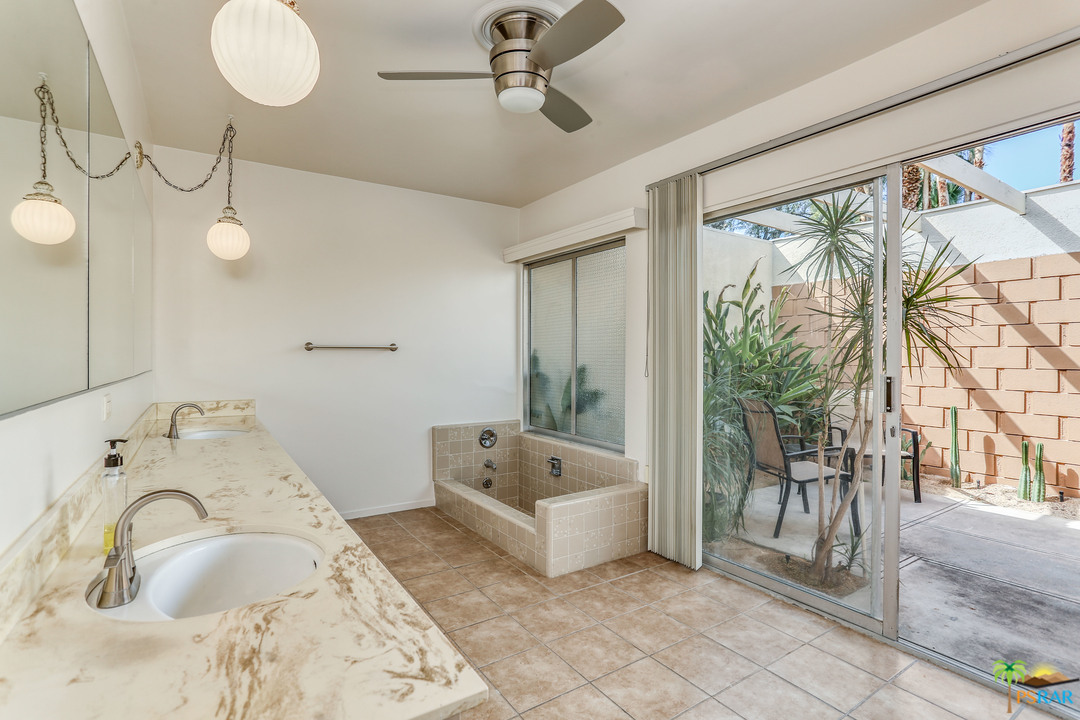 1855 Ramon Road, Unit 3 Palm Springs, CA 92264 - Photo 19 of 38 a spacious bathroom with a tub and sink