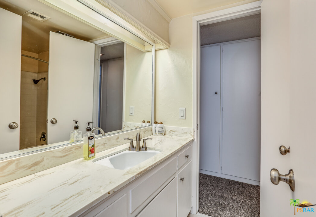 1855 Ramon Road, Unit 3 Palm Springs, CA 92264 - Photo 26 of 38 a bathroom with a double vanity sink and mirror