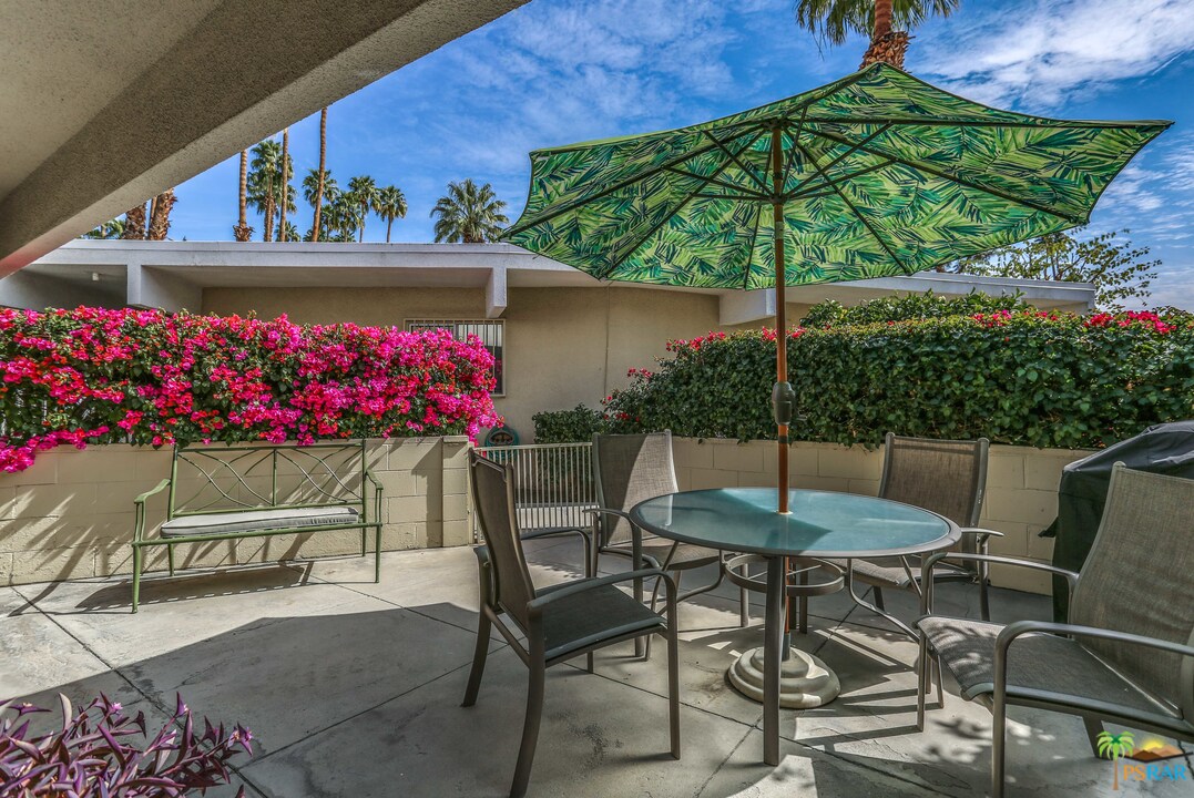1855 Ramon Road, Unit 3 Palm Springs, CA 92264 - Photo 34 of 38 a view of a chairs and table in backyard