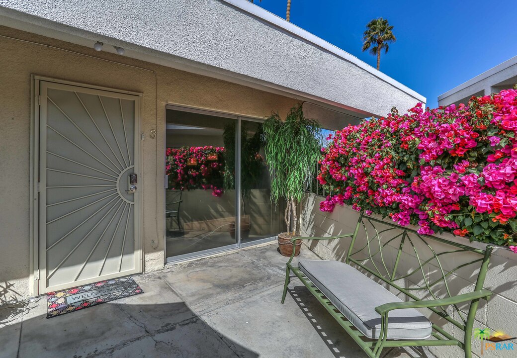 1855 Ramon Road, Unit 3 Palm Springs, CA 92264 - Photo 35 of 38 a wooden bench sitting in front of a building