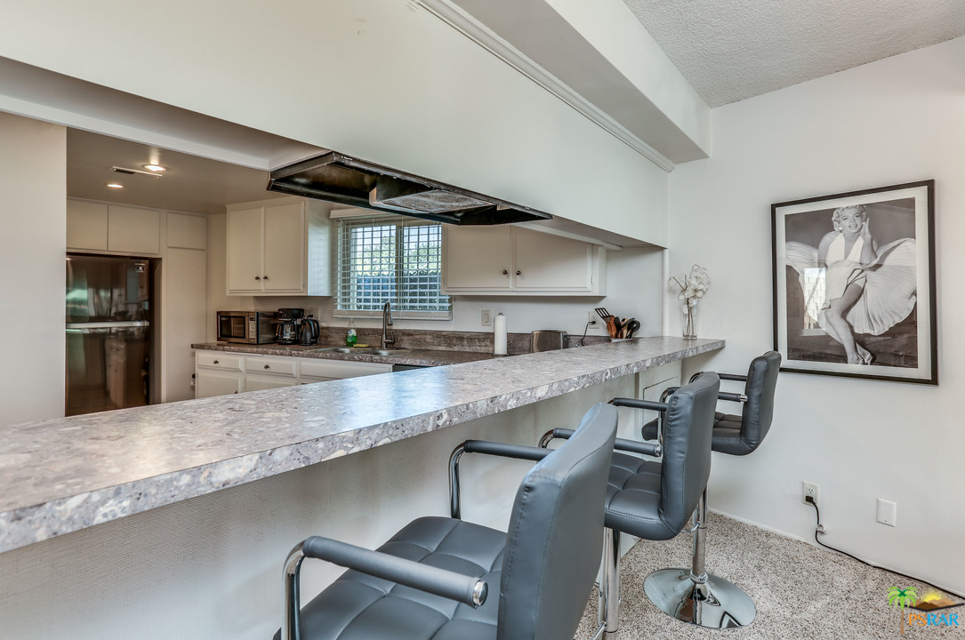 1855 Ramon Road, Unit 3 Palm Springs, CA 92264 - Photo 10 of 38 a kitchen with stainless steel appliances granite countertop a sink a stove and a refrigerator