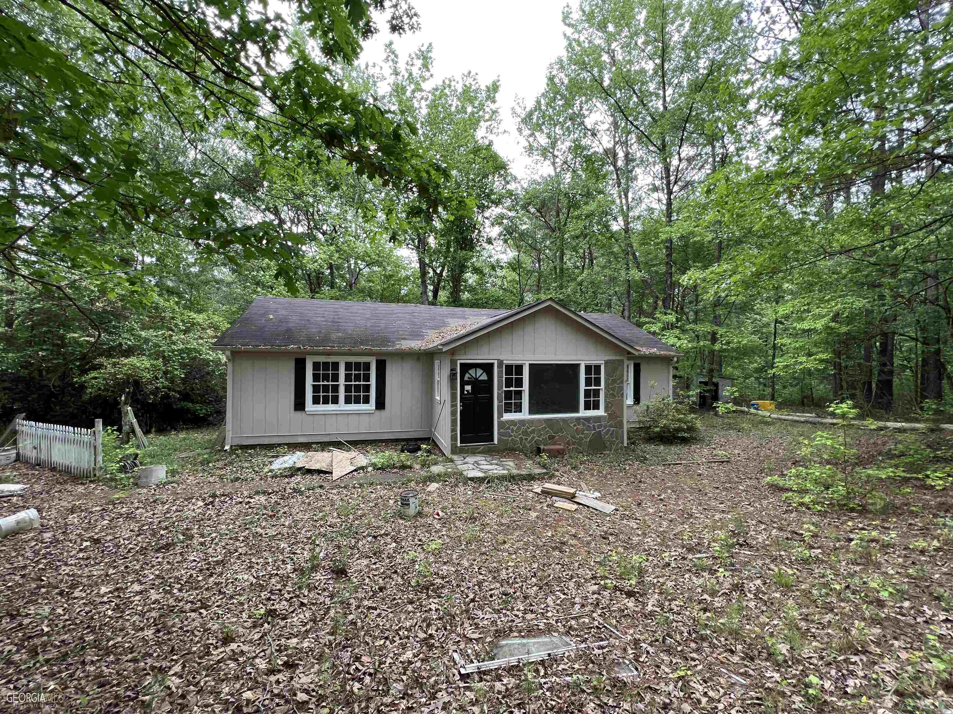 1120 Mocassin Gap Road Locust Grove, GA 30248 - Photo 1 of 1 a house with trees in the background
