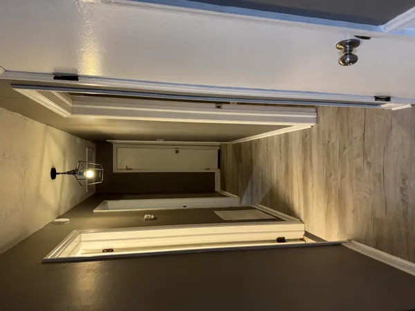 a view of a room with wooden floor