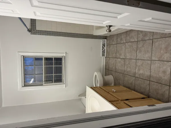 a view of a closet with wooden floor