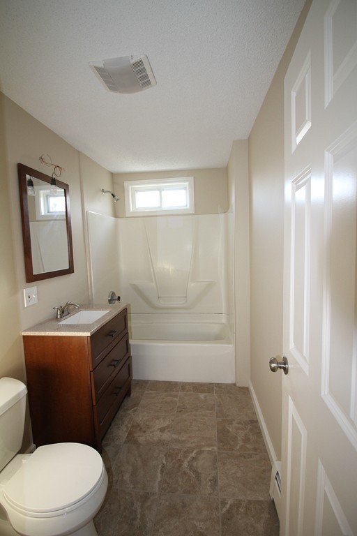 104 Sunapee Street Springfield, MA 01108 - Photo 6 of 11 a bathroom with a toilet a sink and mirror