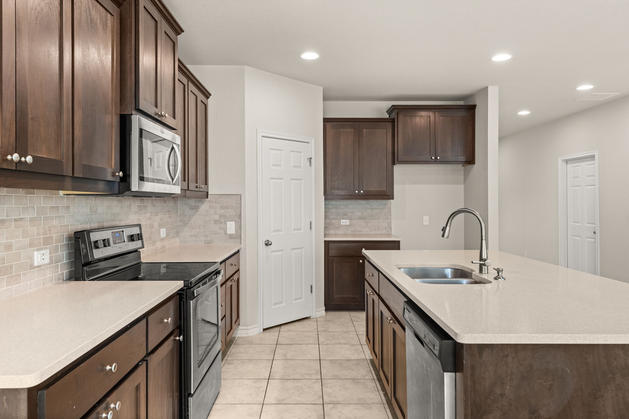 740 Aliso Trail Leander, TX 78641 - Photo 12 of 35 Quartz countertops provide both style and durability for everyday cooking.