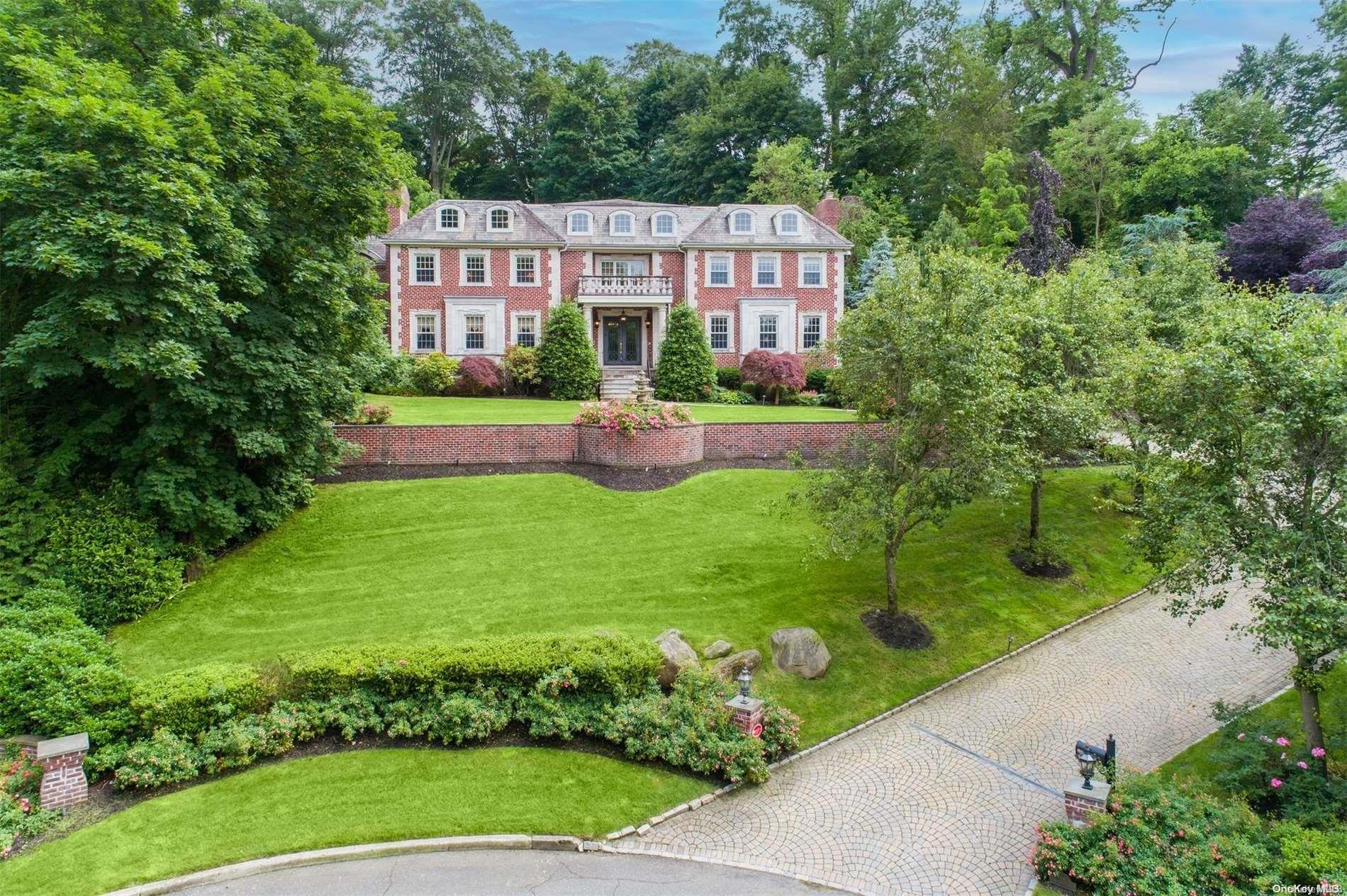 a front view of a house with a yard and potted plants