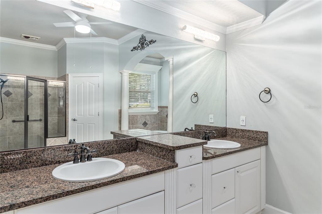 10614 Southwest 15th Lane Gainesville, FL 32607 - Photo 35 of 85 a bathroom with a granite countertop double sink and a mirror