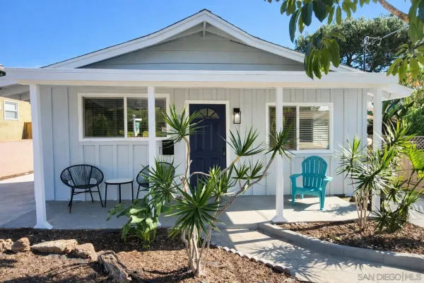 a front view of house with yard seating and green space