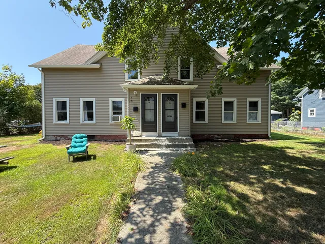 a swimming pool with outdoor seating and yard