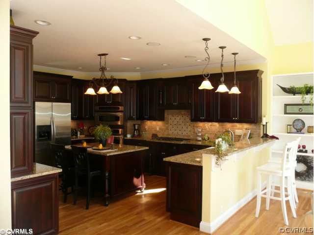 14131 Riverdowns S Drive Midlothian, VA 23113 - Photo 2 of 11 a kitchen with kitchen island granite countertop a sink stove and refrigerator