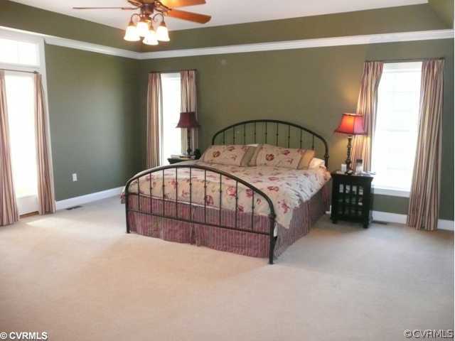 14131 Riverdowns S Drive Midlothian, VA 23113 - Photo 7 of 11 a bedroom with a bed and a chandelier