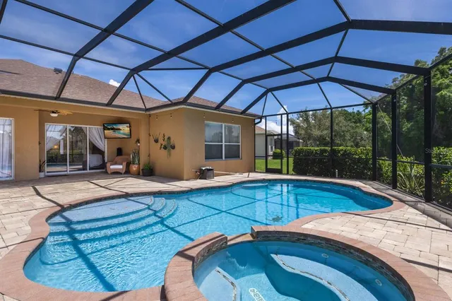 a view of a house with swimming pool and porch with furniture
