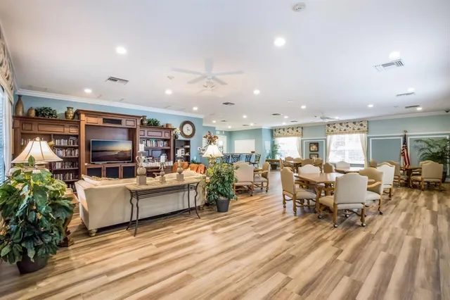 a living room with fireplace furniture and a wooden floor