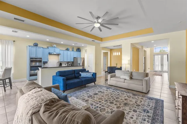 a living room with furniture and a view of kitchen