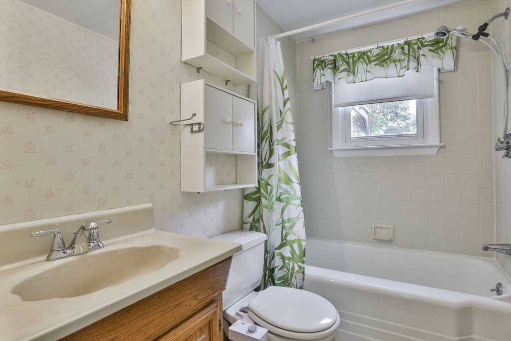 32 Silver Hill Road Maynard, MA 01754 - Photo 28 of 34 a bathroom with a granite countertop sink toilet a mirror and bathtub