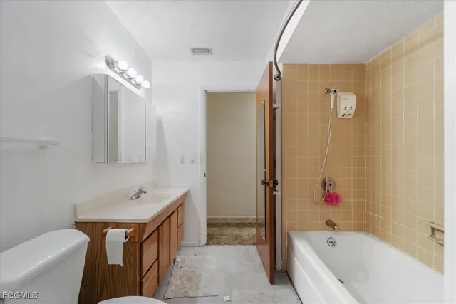 a bathroom with a tub sink and mirror