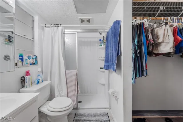 a bathroom with a shower toilet and sink