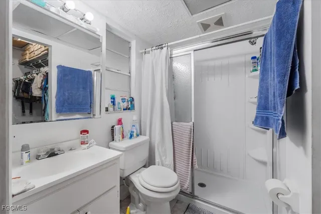 a bathroom with a sink toilet vanity and shower