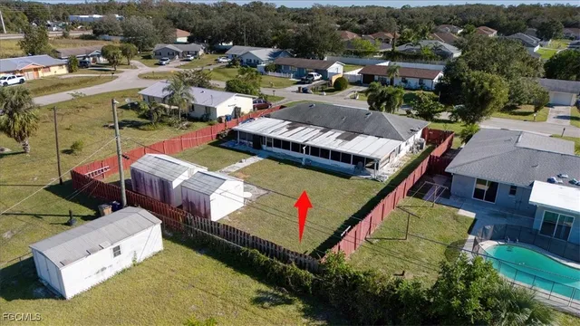 an aerial view of a house with a yard and lake view