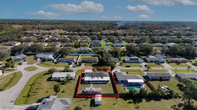 an aerial view of a houses with a swimming pool