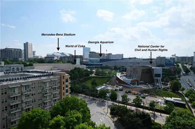 a view of a patio with a dining table and chairs with wooden floor and fence