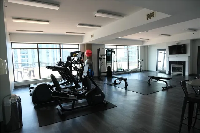 a view of a livingroom with wooden floor and a window