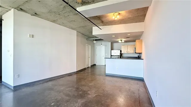 a view of a kitchen with a sink and a refrigerator