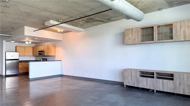 a room with furniture and kitchen view