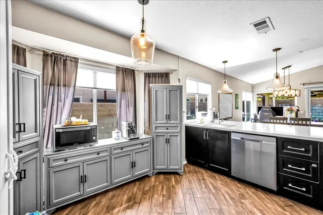 a large kitchen with a large window and stainless steel appliances