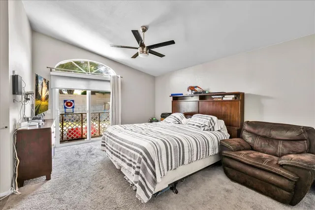 a bedroom with a bed couch and a window