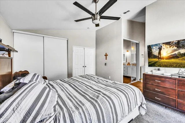 a bedroom with a bed and a flat screen tv