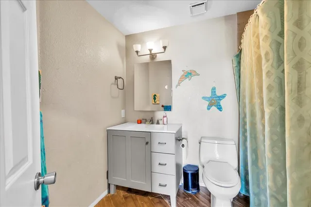 a bathroom with a sink toilet and shower