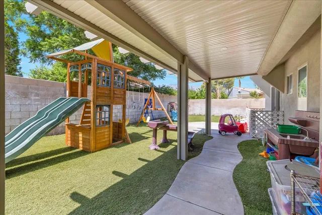 a view of a patio with table and chairs potted plants with floor to ceiling window