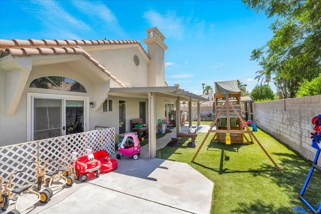 a view of a park with furniture and a small deck