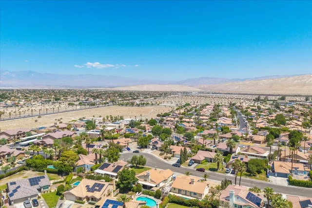 an aerial view of residential houses with outdoor space