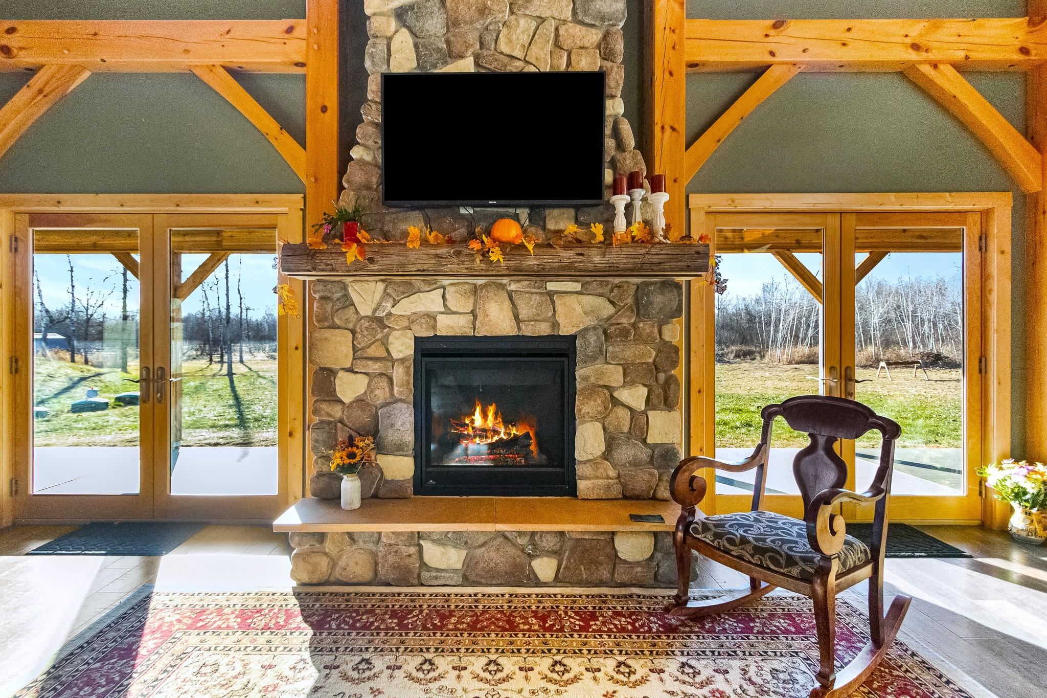 6014 Brown Road Kettle River, MN 55757 - Photo 6 of 54 Living area featuring french doors, healthy amount of natural light, and a fireplace