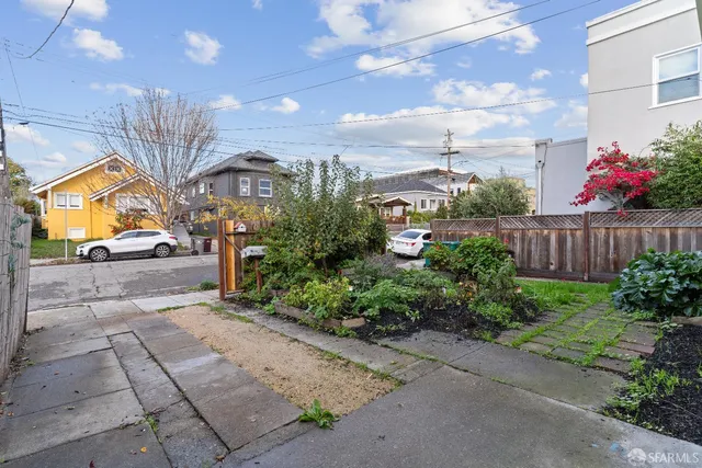 a view of a pathway of a house with wooden fence