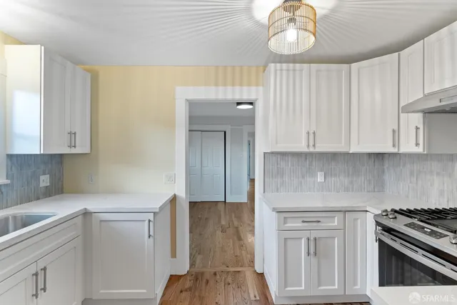 a kitchen with cabinets and appliances