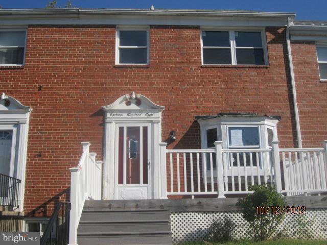 1808 Burnwood Road Baltimore, MD 21239 - Photo 1 of 25 a front view of a house with a garden