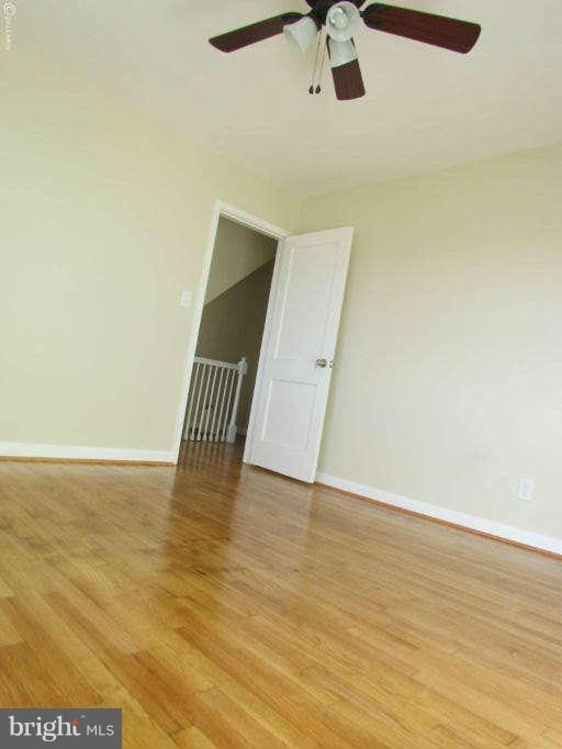 1808 Burnwood Road Baltimore, MD 21239 - Photo 15 of 25 a view of an empty room with wooden floor